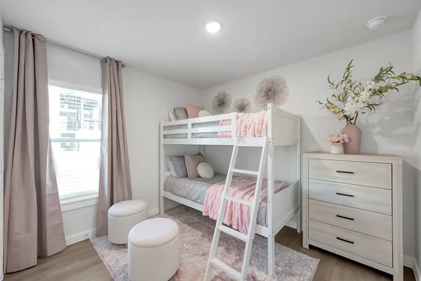 a bedroom with a bed and a chair