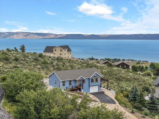 608 Fremont Road Fish Haven, ID 83287 - Photo 32 of 35 Blue siding residence featuring an attached garage, upper-level deck, and paved driveway