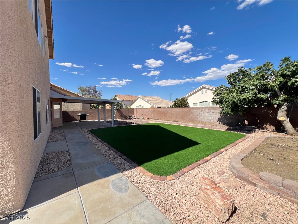 330 Forest Ridge Street Henderson, NV 89014 - Photo 32 of 45 Backyard with covered patio, artificial grass, pond and fruit tree.