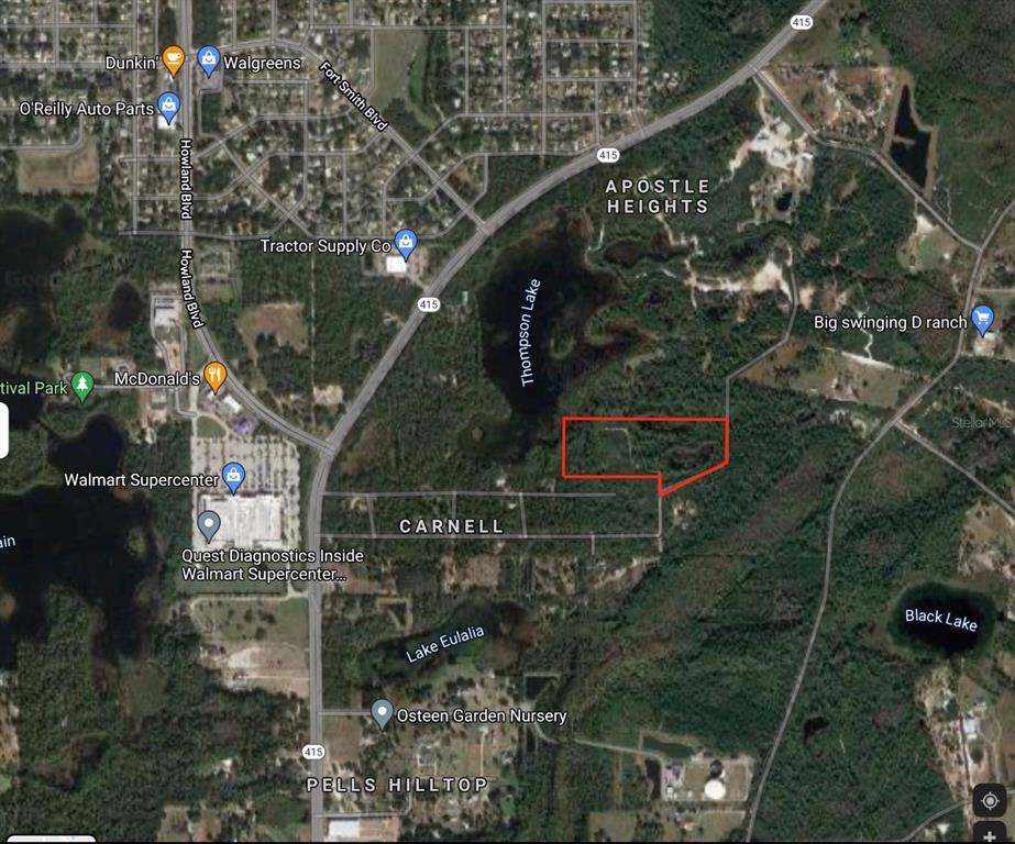 a backyard of a house with lots of green space and plants