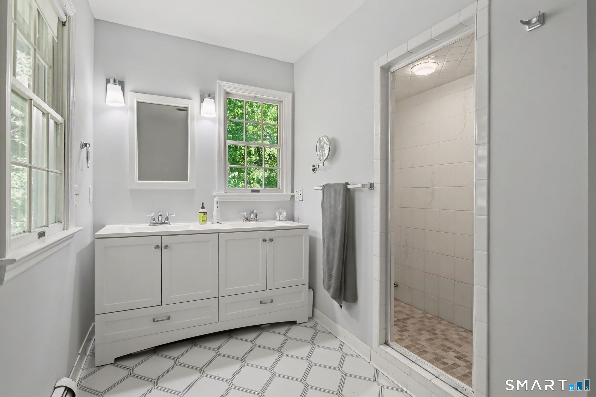 2 Rising Road Norwalk, CT 06850 - Photo 18 of 33 a bathroom with a sink a mirror and a shower