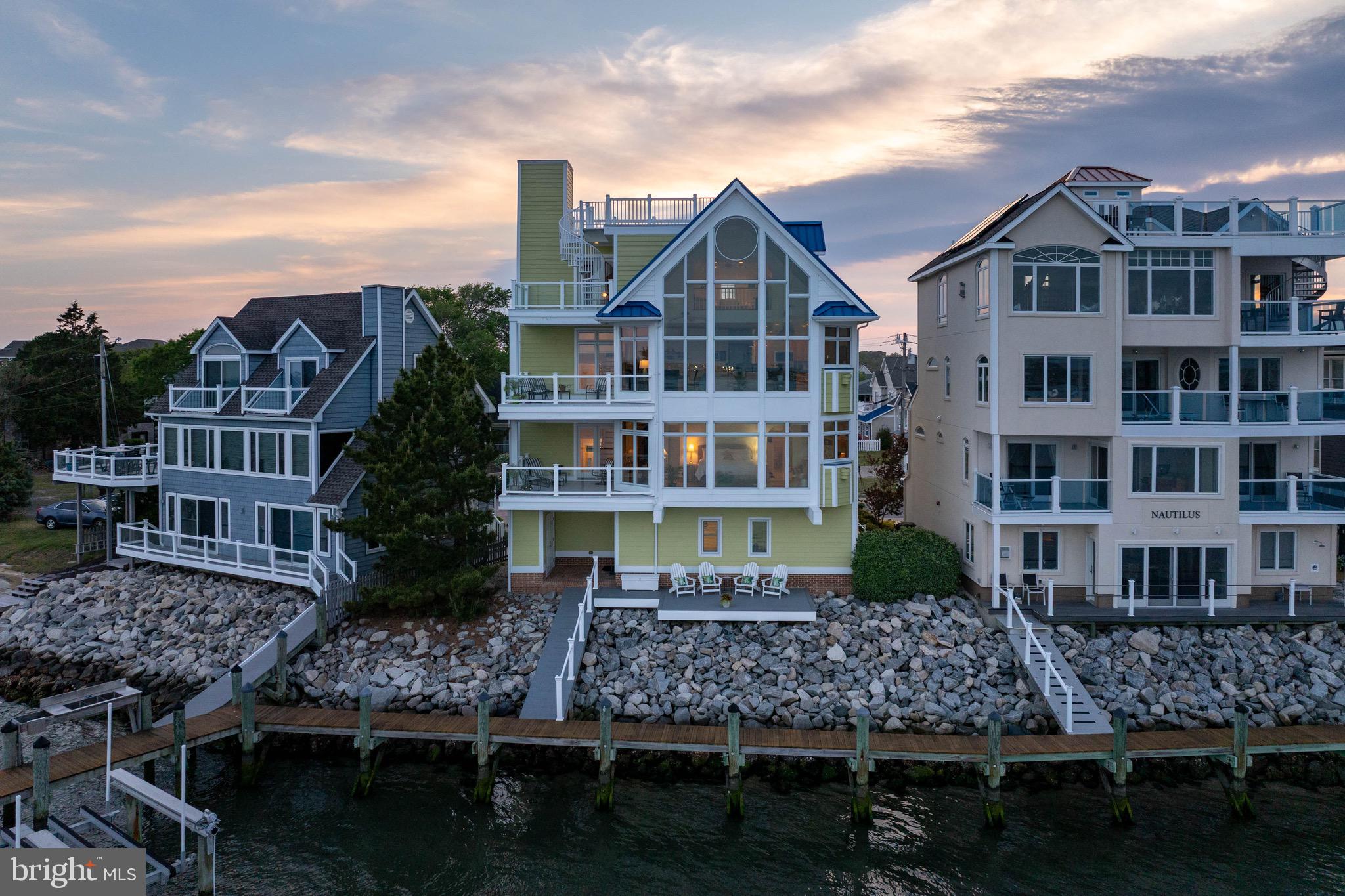 12959 Harbor Road Ocean City, MD 21842 - Photo 63 of 85 a front view of a residential apartment building with a yard