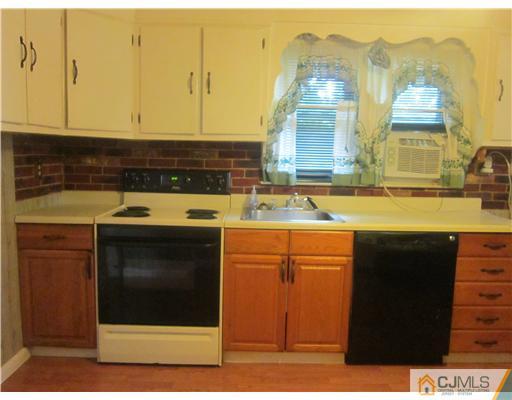 2 Cannon Road East Brunswick, NJ 08816 - Photo 11 of 17 a kitchen with stainless steel appliances granite countertop a stove a sink and a microwave