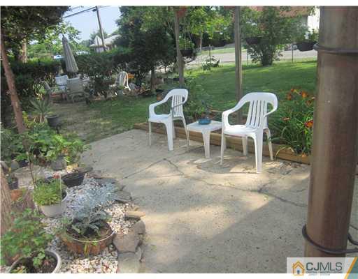 2 Cannon Road East Brunswick, NJ 08816 - Photo 5 of 17 a view of a chair and table on the garden