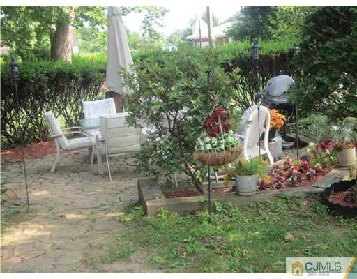 2 Cannon Road East Brunswick, NJ 08816 - Photo 7 of 17 a view of a chair and table in the garden