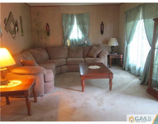 2 Cannon Road East Brunswick, NJ 08816 - Photo 8 of 17 a living room with furniture and a chandelier