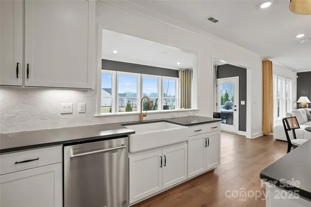 a kitchen with a sink stove and cabinets