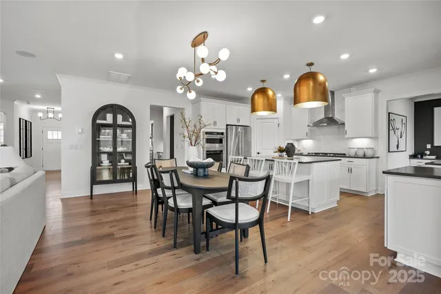 a view of a dining room with furniture and chandelier