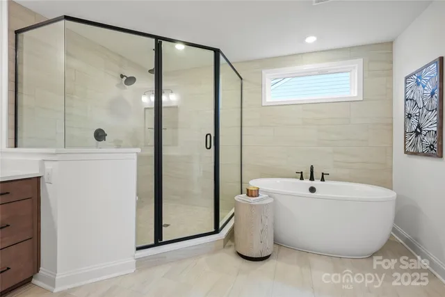 a spacious bathroom with a double vanity sink a mirror and a bathtub