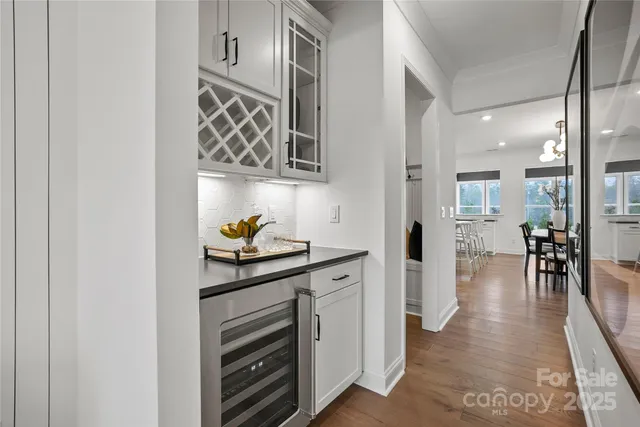 a hallway with cabinets and painting on the wall