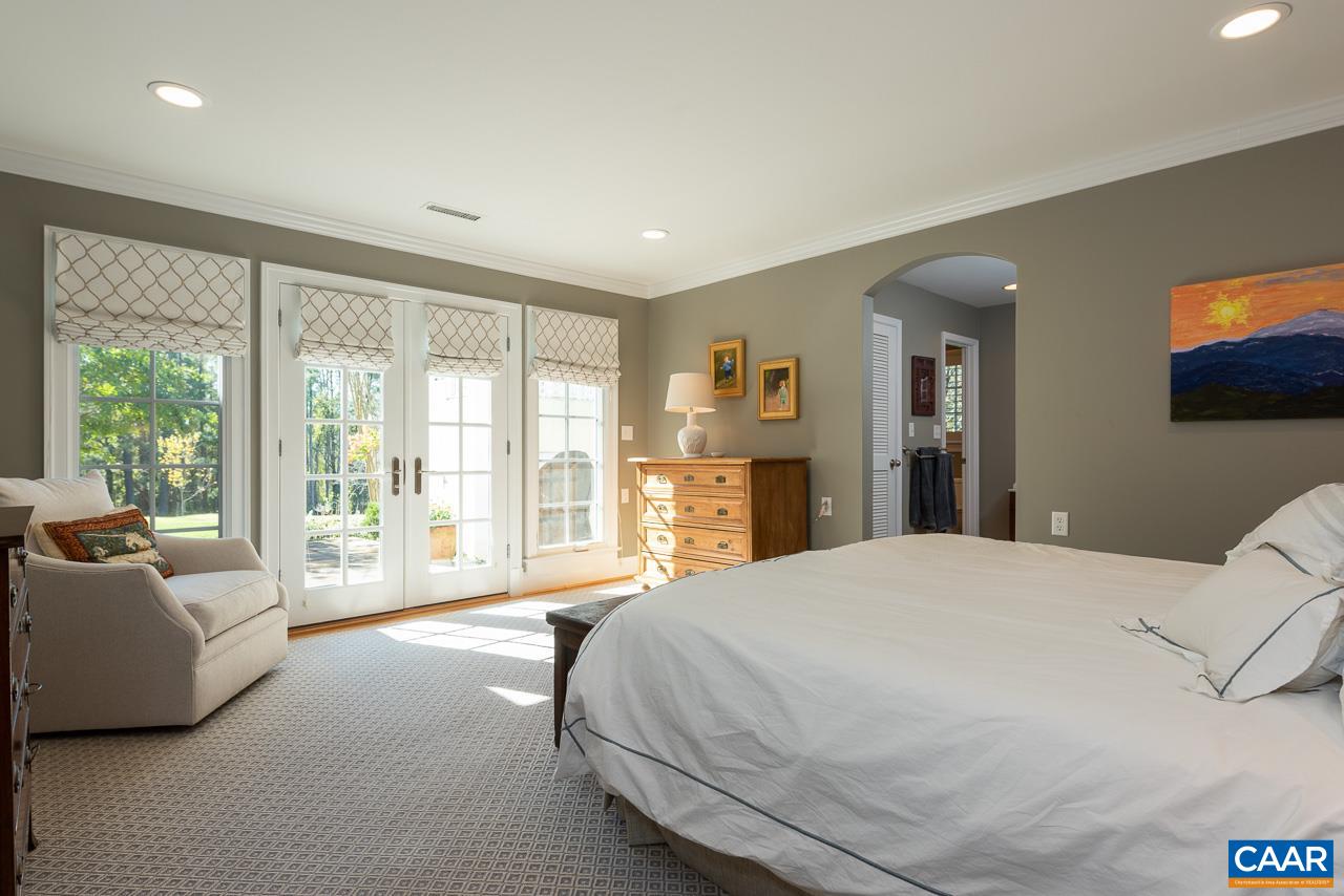11 Orchard Road Charlottesville, VA 22903 - Photo 23 of 50 a spacious bedroom with a large bed and a large window