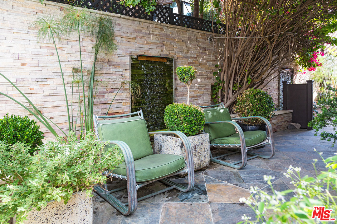 21644 Pacific Coast Highway Malibu, CA 90265 - Photo 2 of 53 a view of a chair and table in backyard of the house