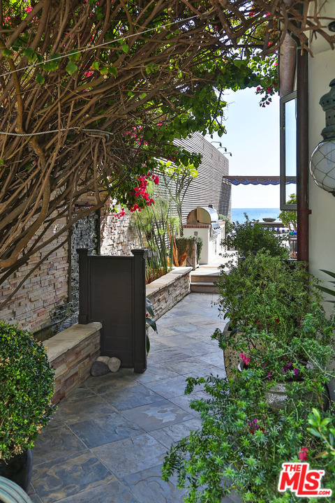21644 Pacific Coast Highway Malibu, CA 90265 - Photo 3 of 53 a front view of a house with a yard