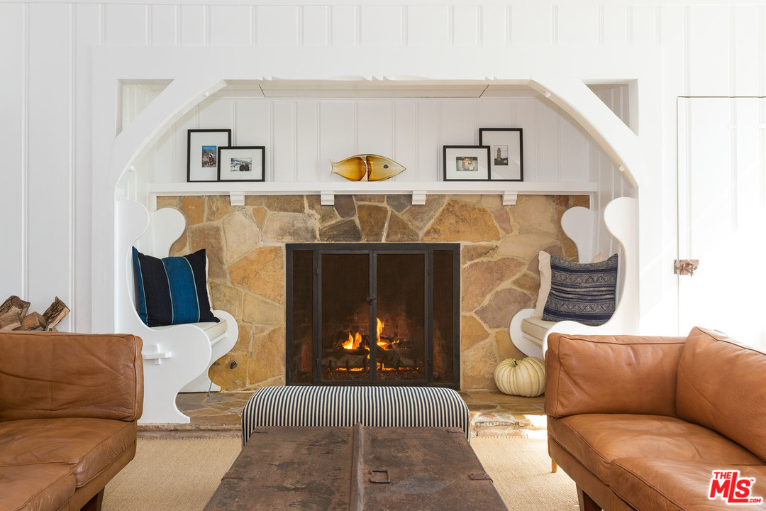 21644 Pacific Coast Highway Malibu, CA 90265 - Photo 21 of 53 a living room with furniture and a fireplace