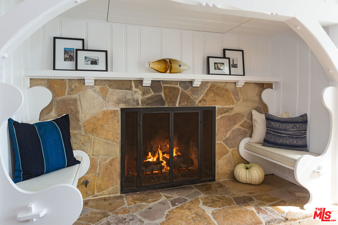 21644 Pacific Coast Highway Malibu, CA 90265 - Photo 23 of 53 a living room with furniture and a fireplace