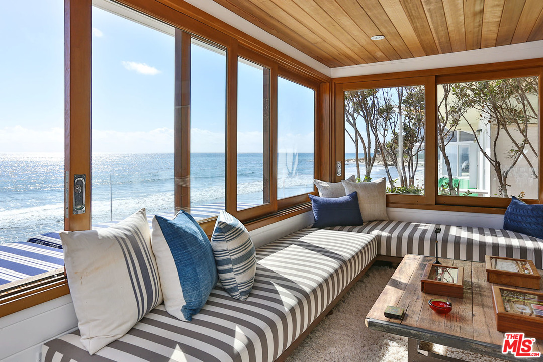 21644 Pacific Coast Highway Malibu, CA 90265 - Photo 27 of 53 a bedroom with furniture and large windows
