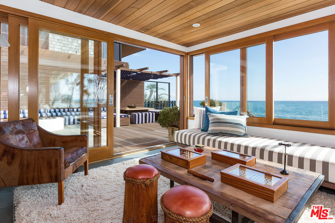 21644 Pacific Coast Highway Malibu, CA 90265 - Photo 29 of 53 a living room with furniture and a floor to ceiling window