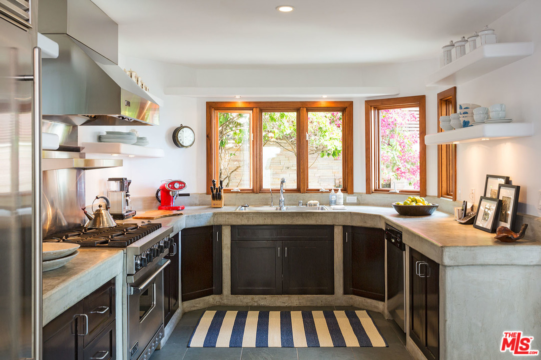 21644 Pacific Coast Highway Malibu, CA 90265 - Photo 38 of 53 a kitchen with a sink stove and cabinets