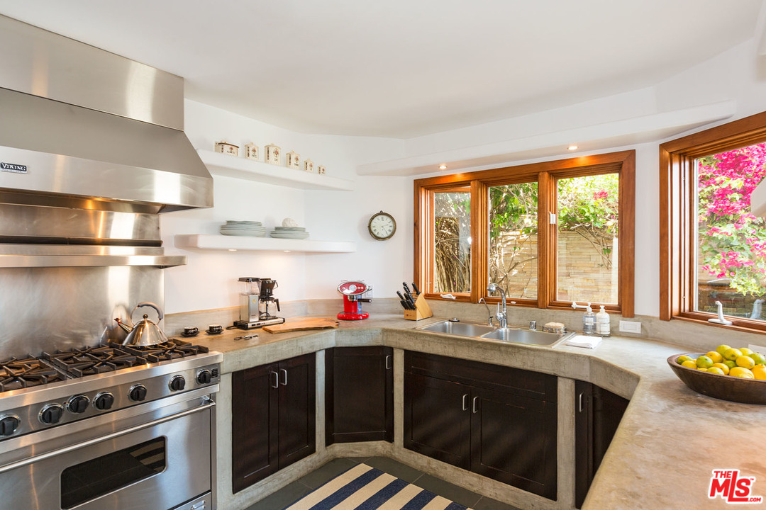 21644 Pacific Coast Highway Malibu, CA 90265 - Photo 39 of 53 a kitchen with a sink stove and cabinets
