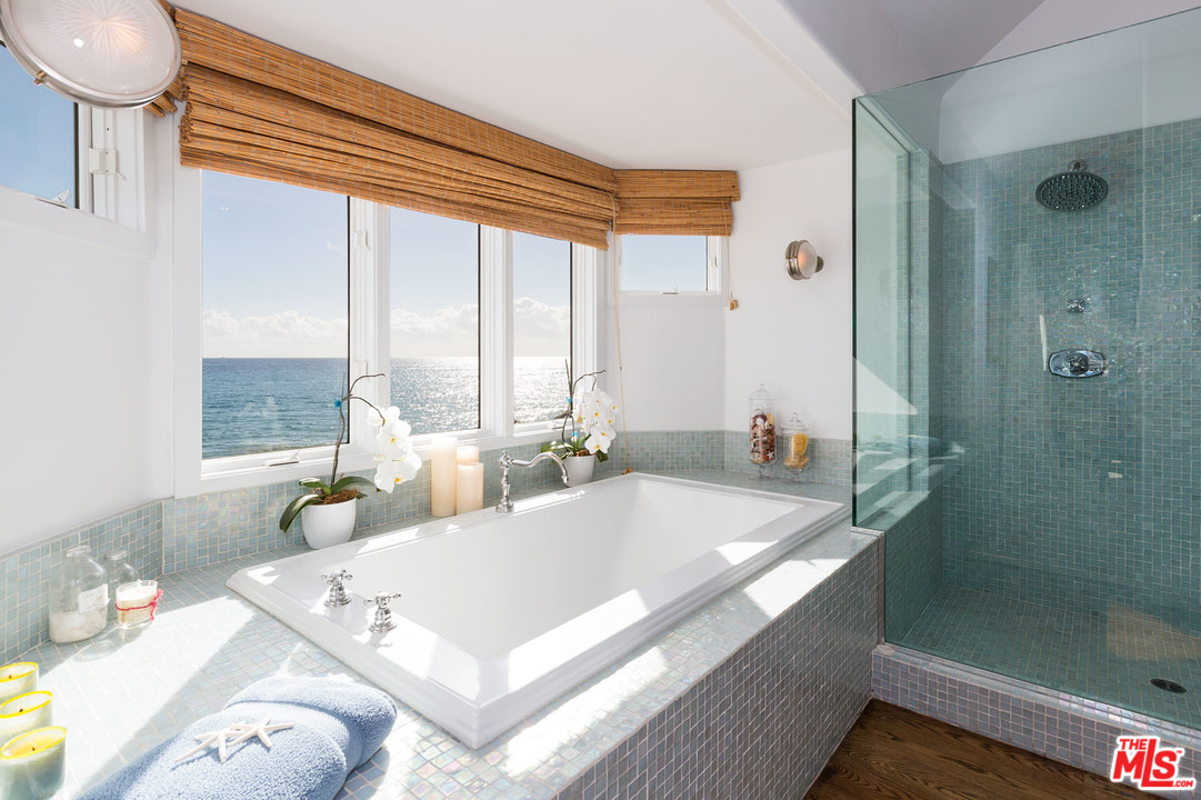 21644 Pacific Coast Highway Malibu, CA 90265 - Photo 49 of 53 a large white tub sitting in a bathroom next to a window