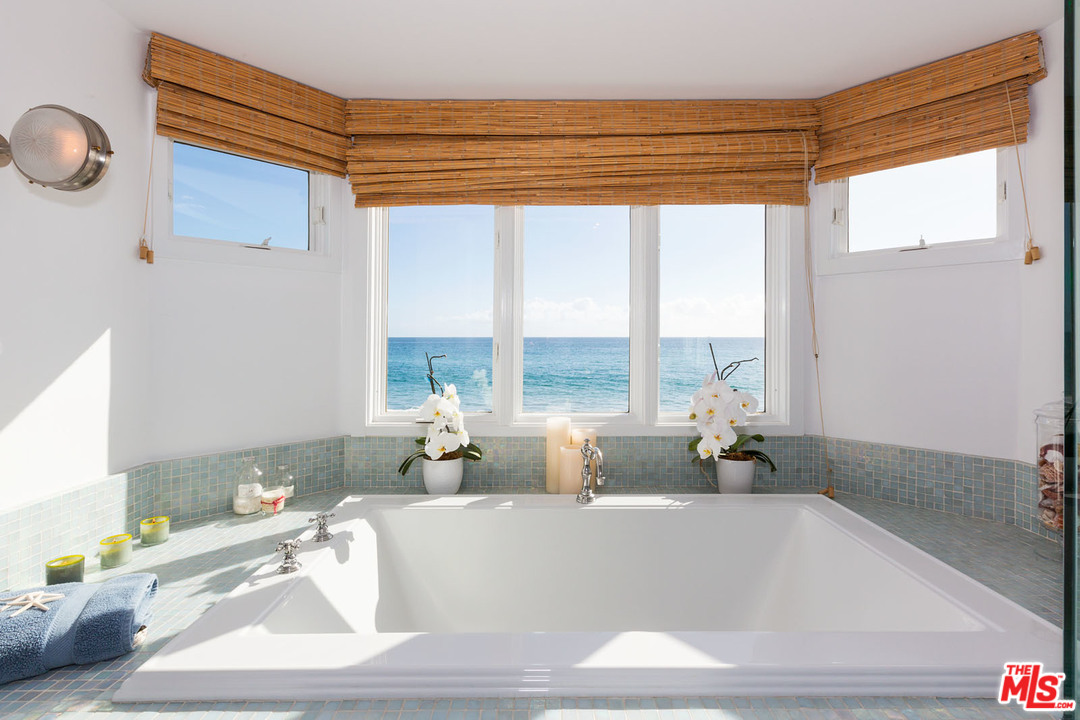 21644 Pacific Coast Highway Malibu, CA 90265 - Photo 50 of 53 a white bath tub sitting in a bathroom next to a window