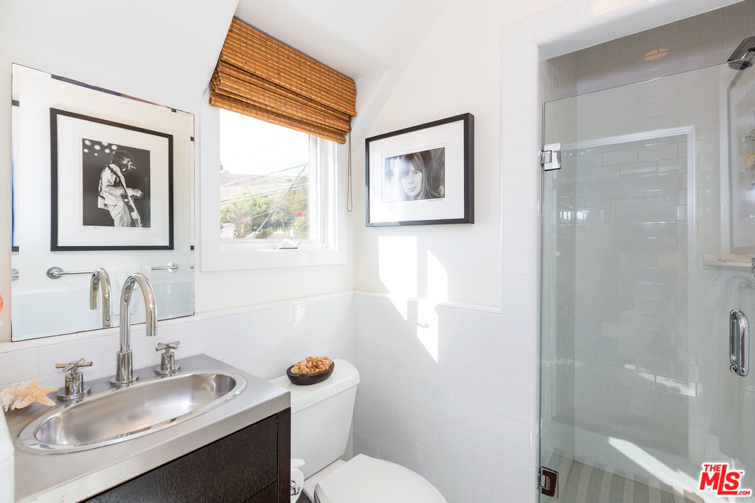 21644 Pacific Coast Highway Malibu, CA 90265 - Photo 53 of 53 a bathroom with a toilet sink and mirror