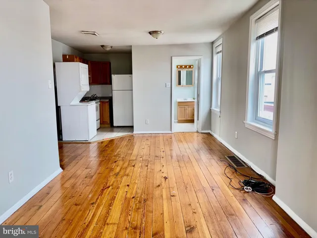 a view of kitchen with cabinets and wooden floor
