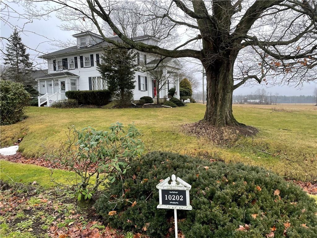 10202 Cutter Road Meadville, PA 16335 - Photo 2 of 9 a sign board with yard of house and trees in the background