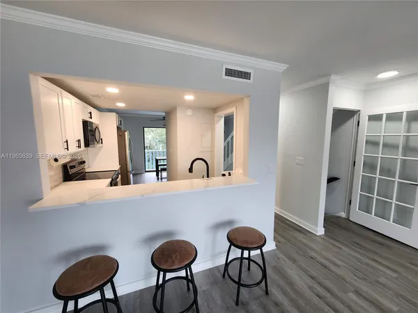 a view of a room with wooden floor and furniture