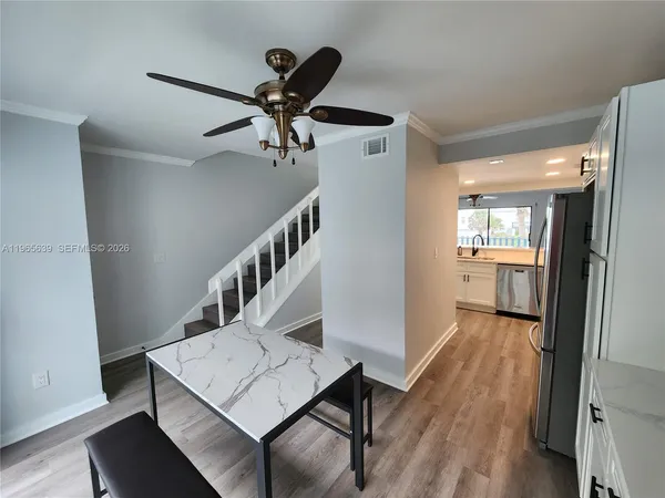 a view of entryway and hall with wooden floor