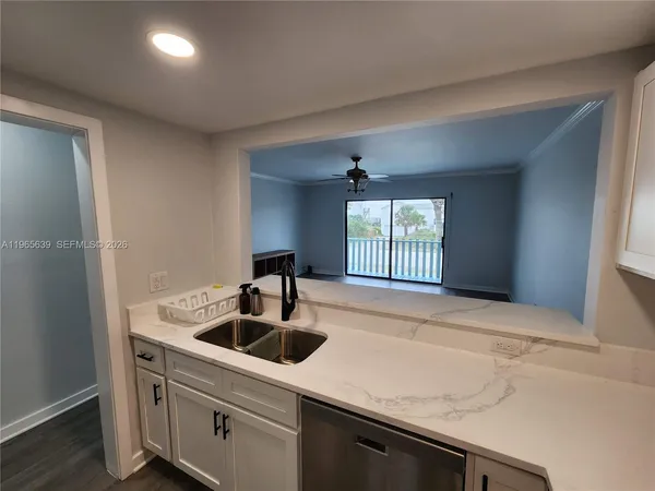 a kitchen with a sink cabinets and window