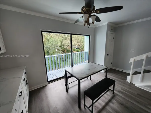 a view of a room with furniture wooden floor and fan