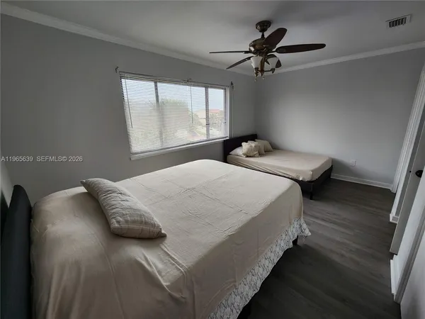 a bedroom with bed and window