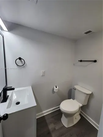a white toilet sitting next to a bathroom sink