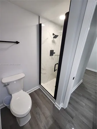a bathroom with a toilet and a shower