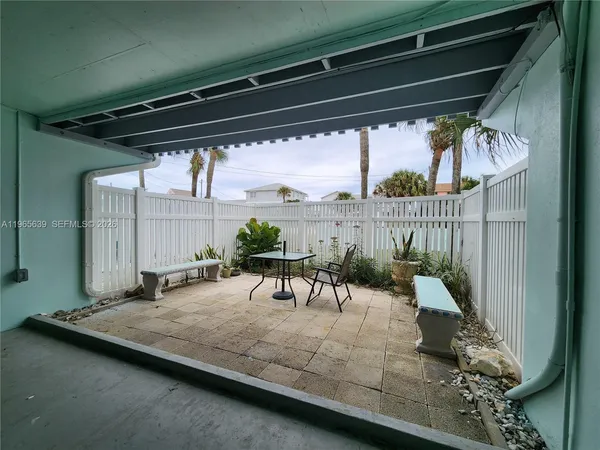 a view of a porch with furniture and a table
