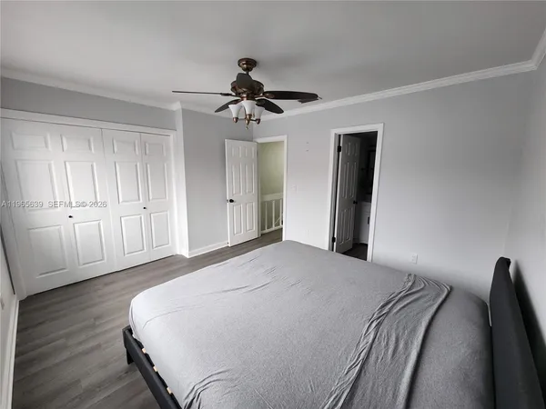 a spacious bedroom with a bed and a chandelier