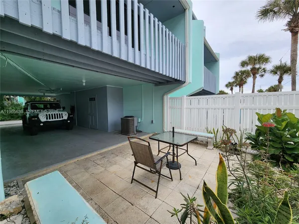 a view of a chairs and table in the patio