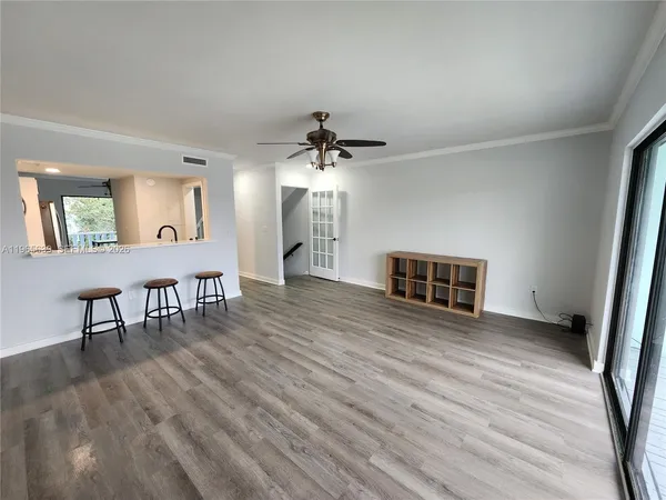 a view of a livingroom with furniture and a ceiling fan
