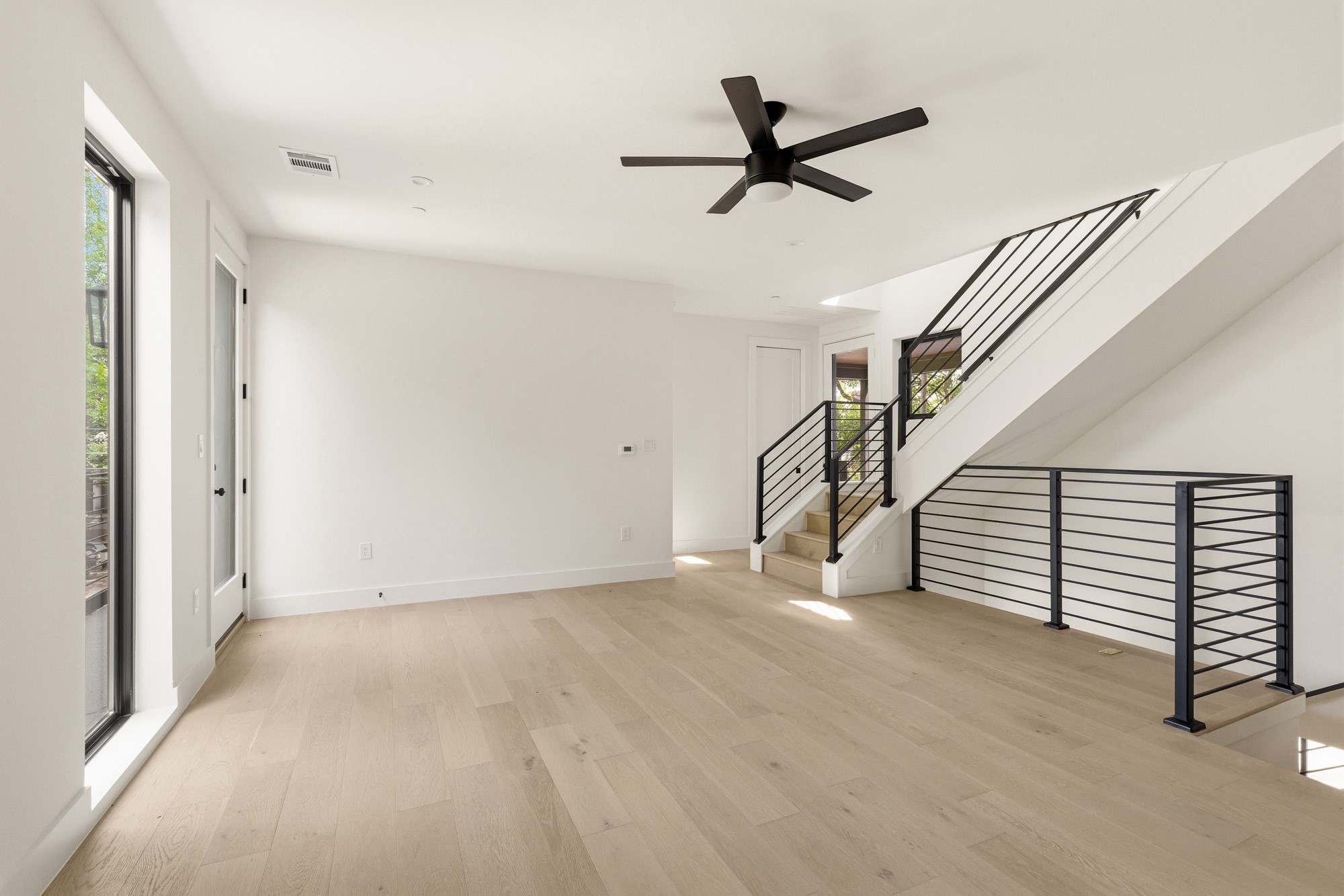 2300 Bluebonnet Lane Austin, TX 78704 - Photo 21 of 40 a view of empty room with stairs and a ceiling fan