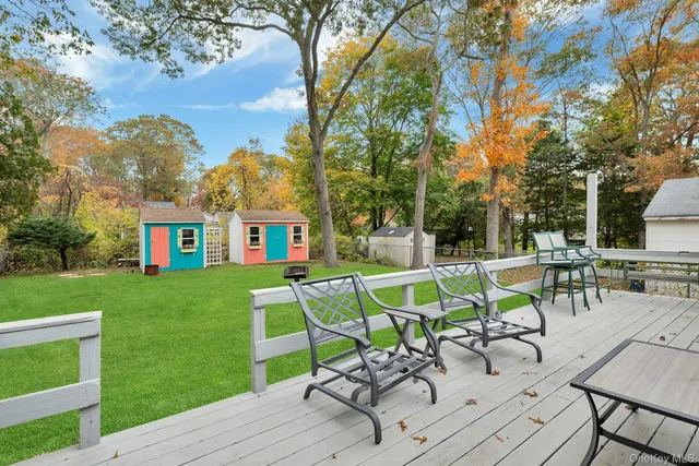 a view of house with a backyard and sitting area