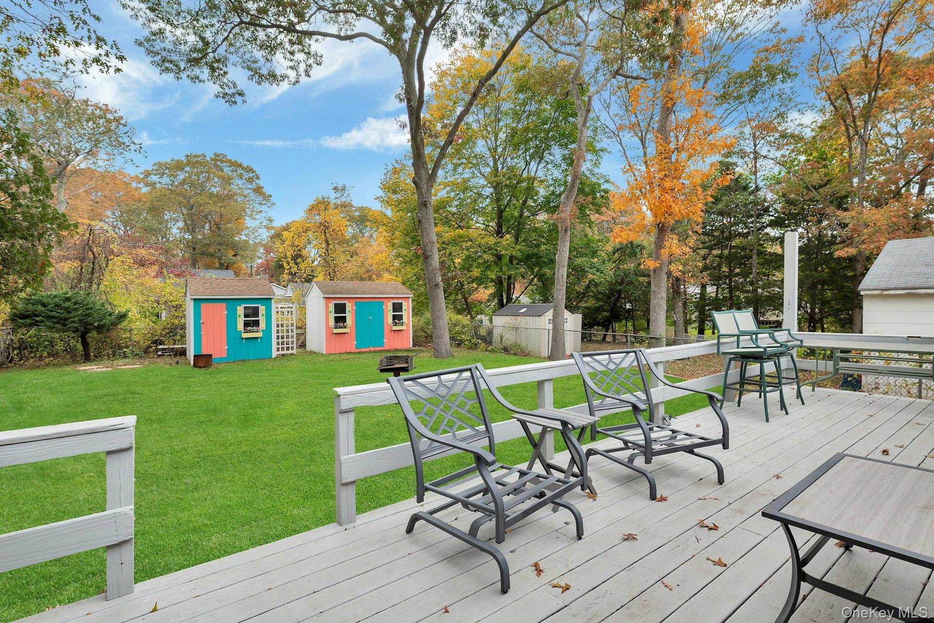 210 3rd Street Laurel, NY 11948 - Photo 15 of 22 Deck with a storage unit and view of scattered trees