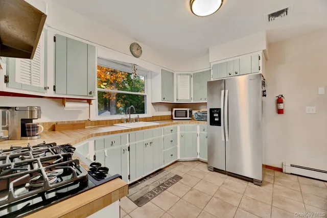 a kitchen with a refrigerator and a sink