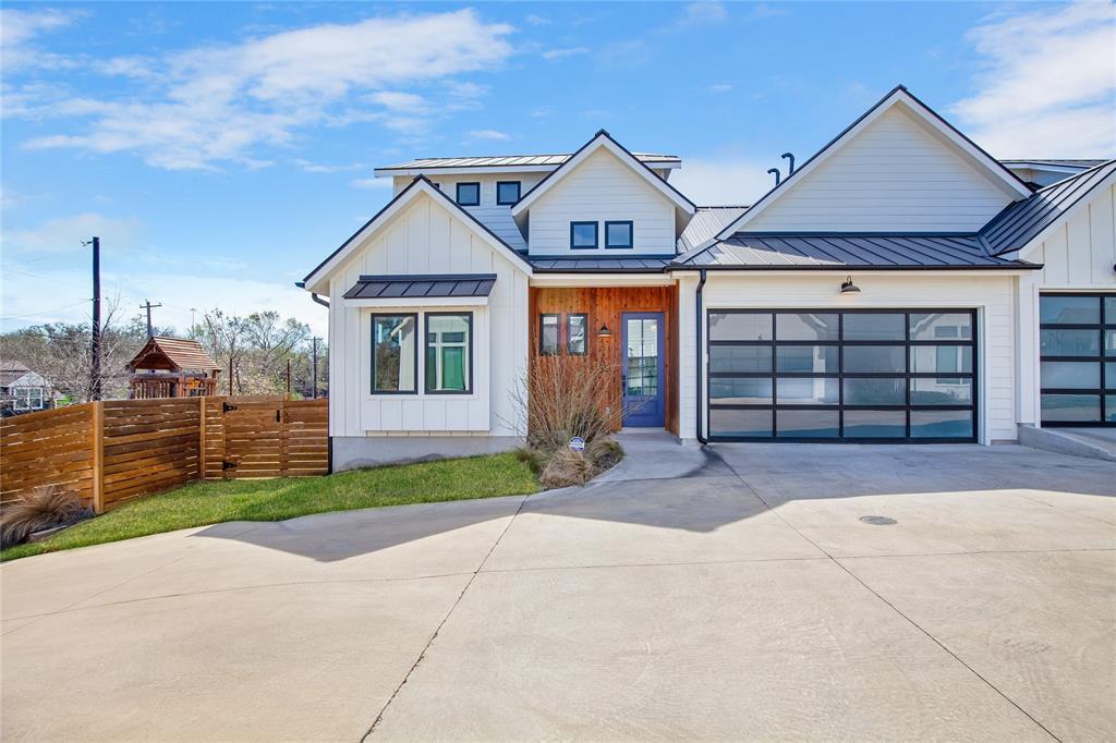 4020 Valley View Road, Unit A Austin, TX 78704 - Photo 17 of 17 Modern inspired farmhouse with a standing seam roof, driveway, and board and batten siding