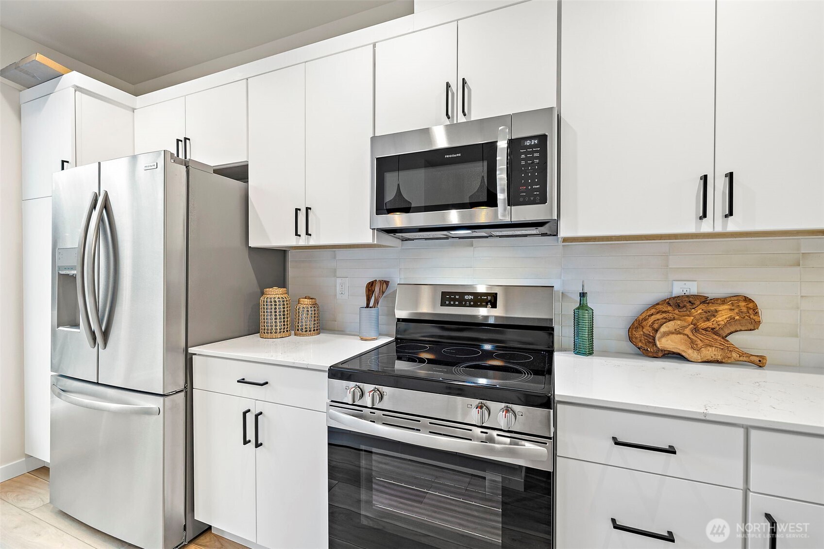5015 144th Street Southwest, Unit C1 Edmonds, WA 98026 - Photo 13 of 36 a kitchen with stainless steel appliances a refrigerator microwave and sink