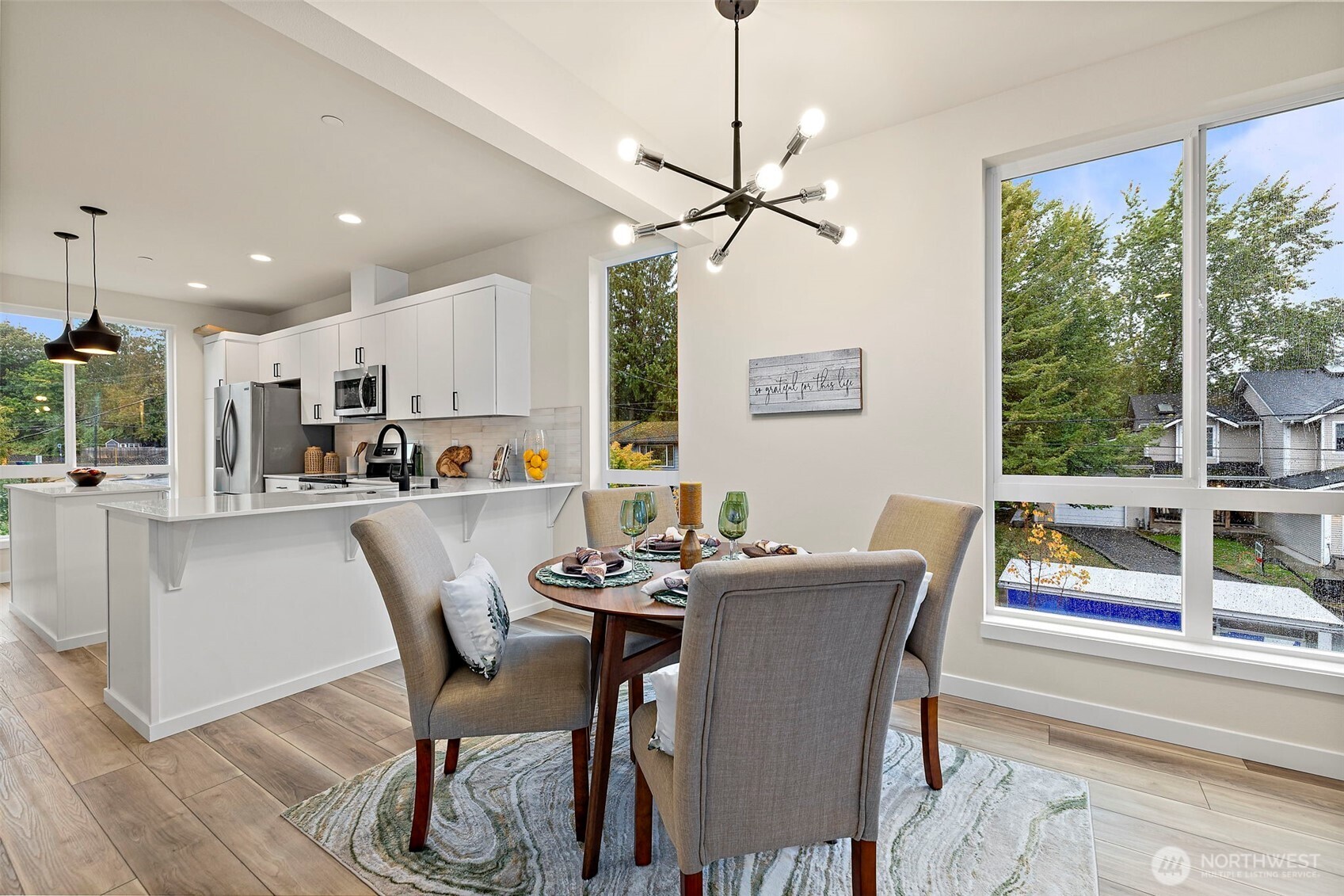 5015 144th Street Southwest, Unit C1 Edmonds, WA 98026 - Photo 22 of 36 a dining room with furniture a chandelier and wooden floor