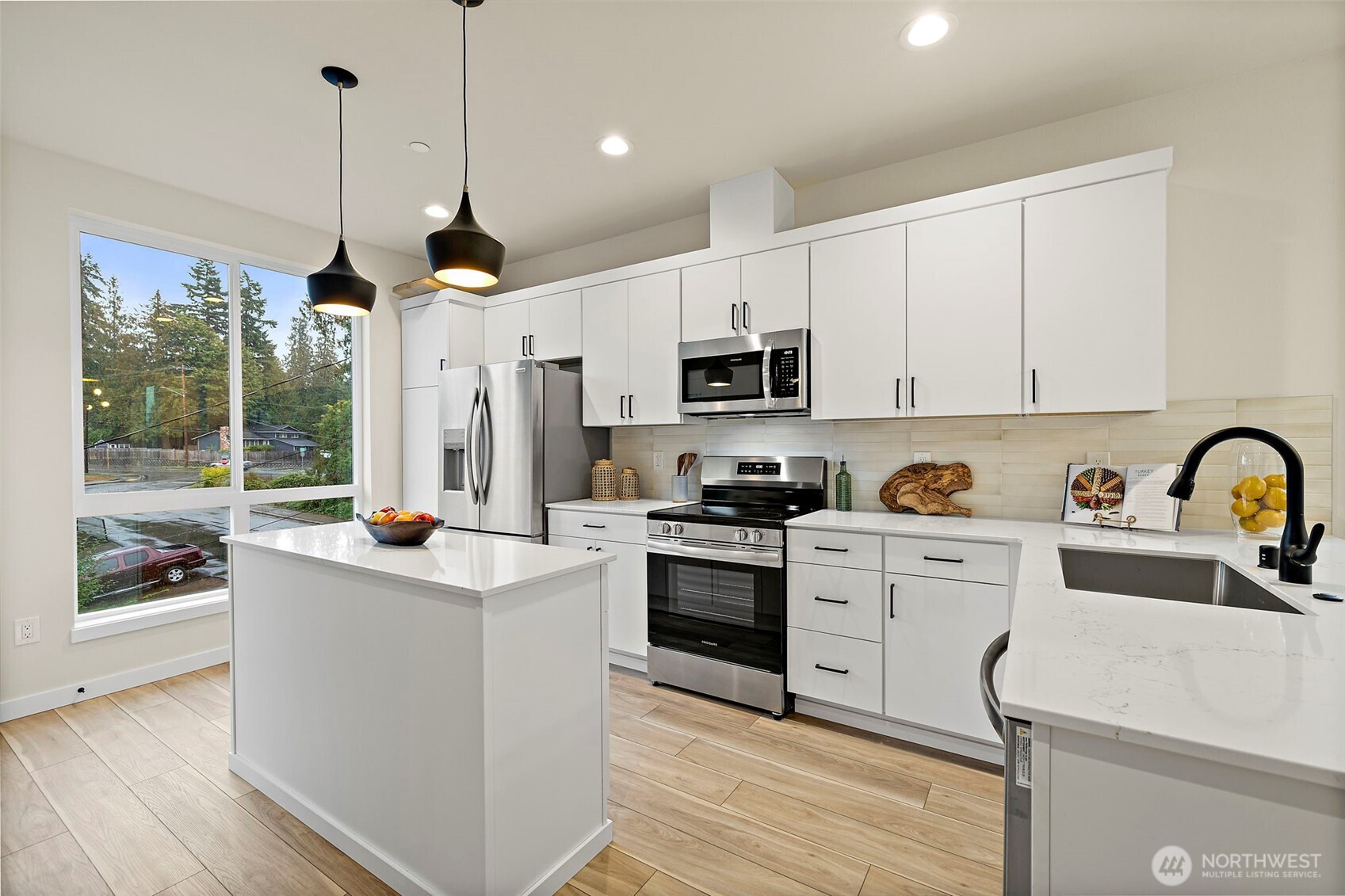 5015 144th Street Southwest, Unit C1 Edmonds, WA 98026 - Photo 10 of 36 a kitchen with kitchen island a sink a counter top space appliances and cabinets