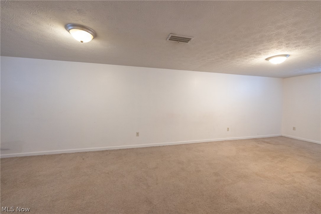 4344 West Anderson Road South Euclid, OH 44121 - Photo 14 of 14 Spare room with light carpet and a textured ceiling