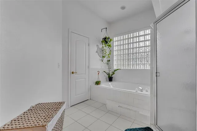 a large kitchen with stainless steel appliances a stove a sink dishwasher a refrigerator and a dining table with wooden floor