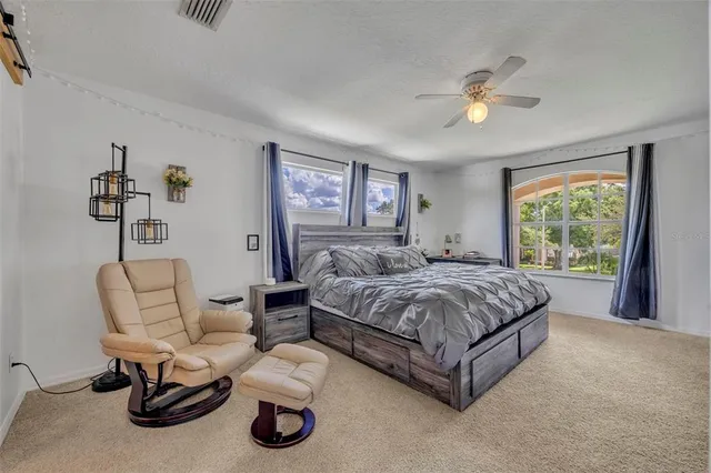 a swimming pool with outdoor seating and yard